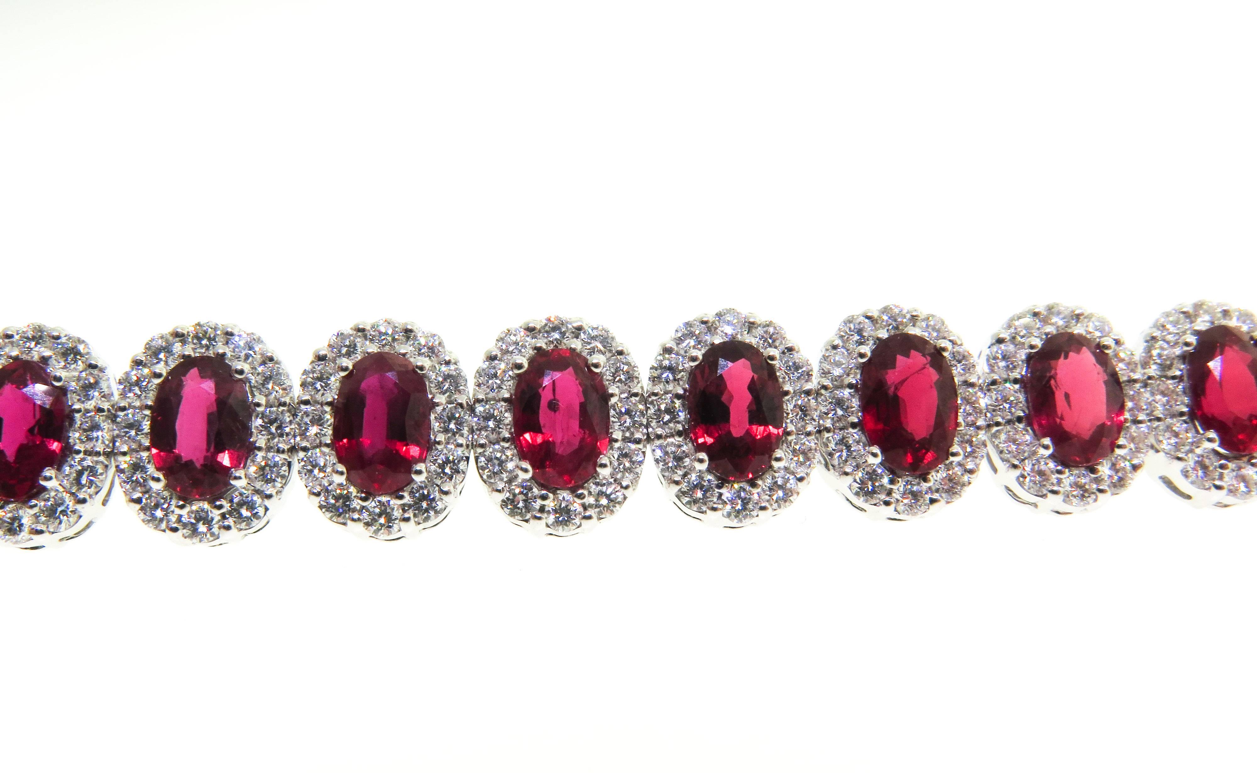 Stunning! This bracelet features 24 beautifully matched rubies, meticulously crafted in 18 karat white gold in the highest quality. Surrounded by white round brilliant cut diamonds. Ruby carat weight 14.18 total and 5.41 carat diamonds. Clasp melts