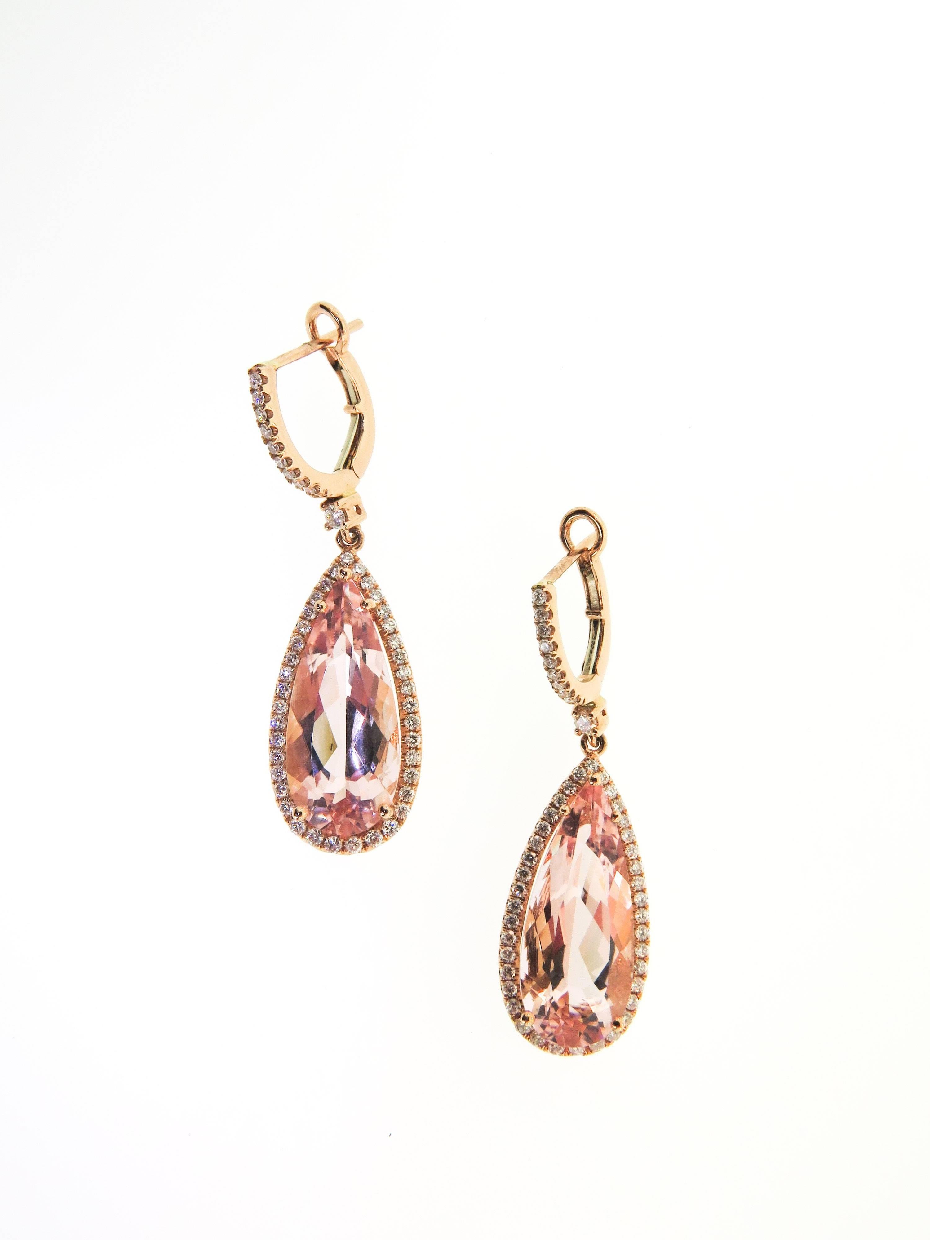 This elegant Morganite drop earrings can be a cocktail earring or just a fun piece of jewelry to complement your everyday outfit. A pair of pear shaped morganites weighing 9.20ctw are surrounded by 96 round cut micro pave diamonds for a total weight