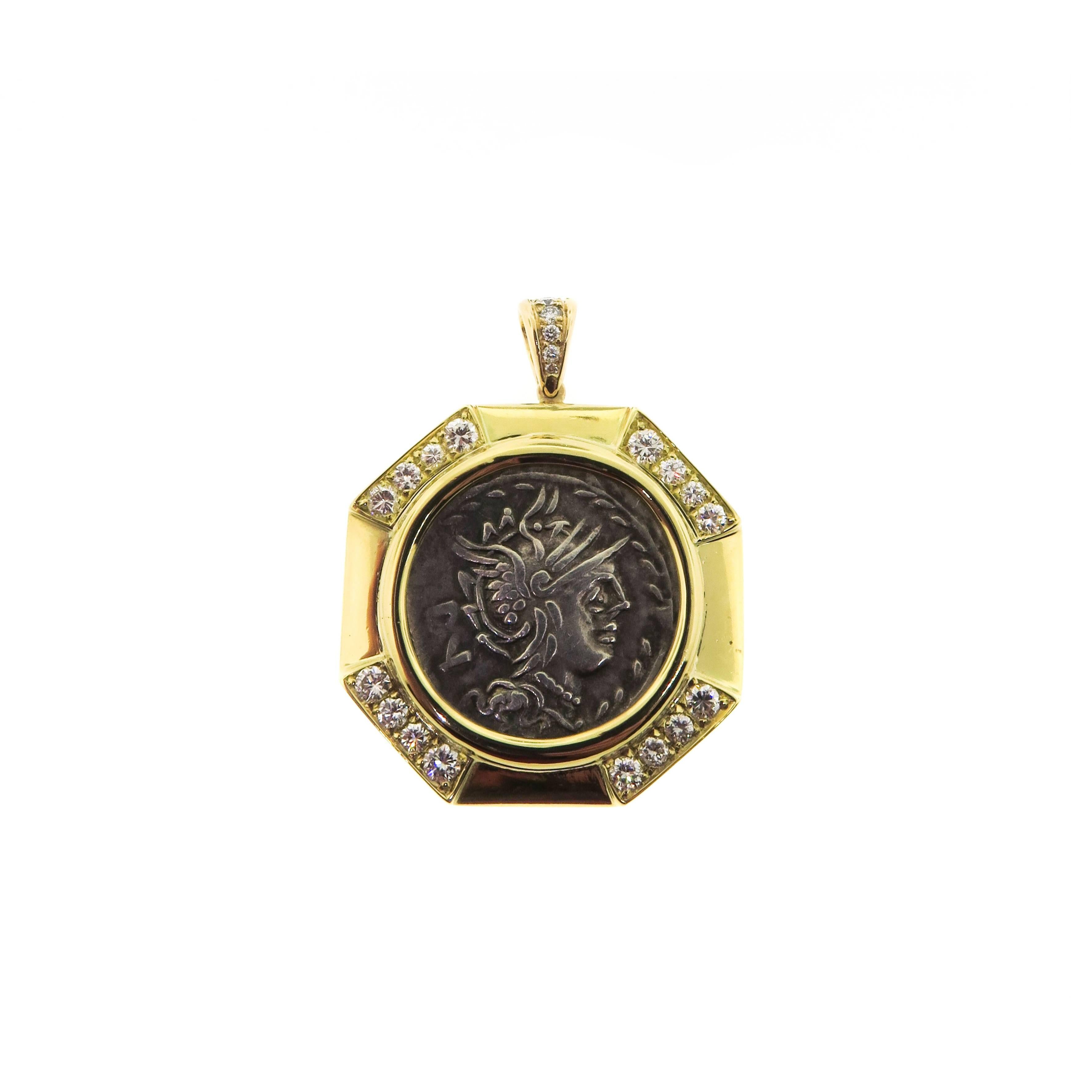 Estate 18k yellow gold necklace featuring a Sterling silver Roman Coin struck by M. Lucilius Rufus in 101 BC with Goddess Roma on one side and Victory Riding Quadriga on the other side. The octagonal frame is detailed with 4 round diamonds at each