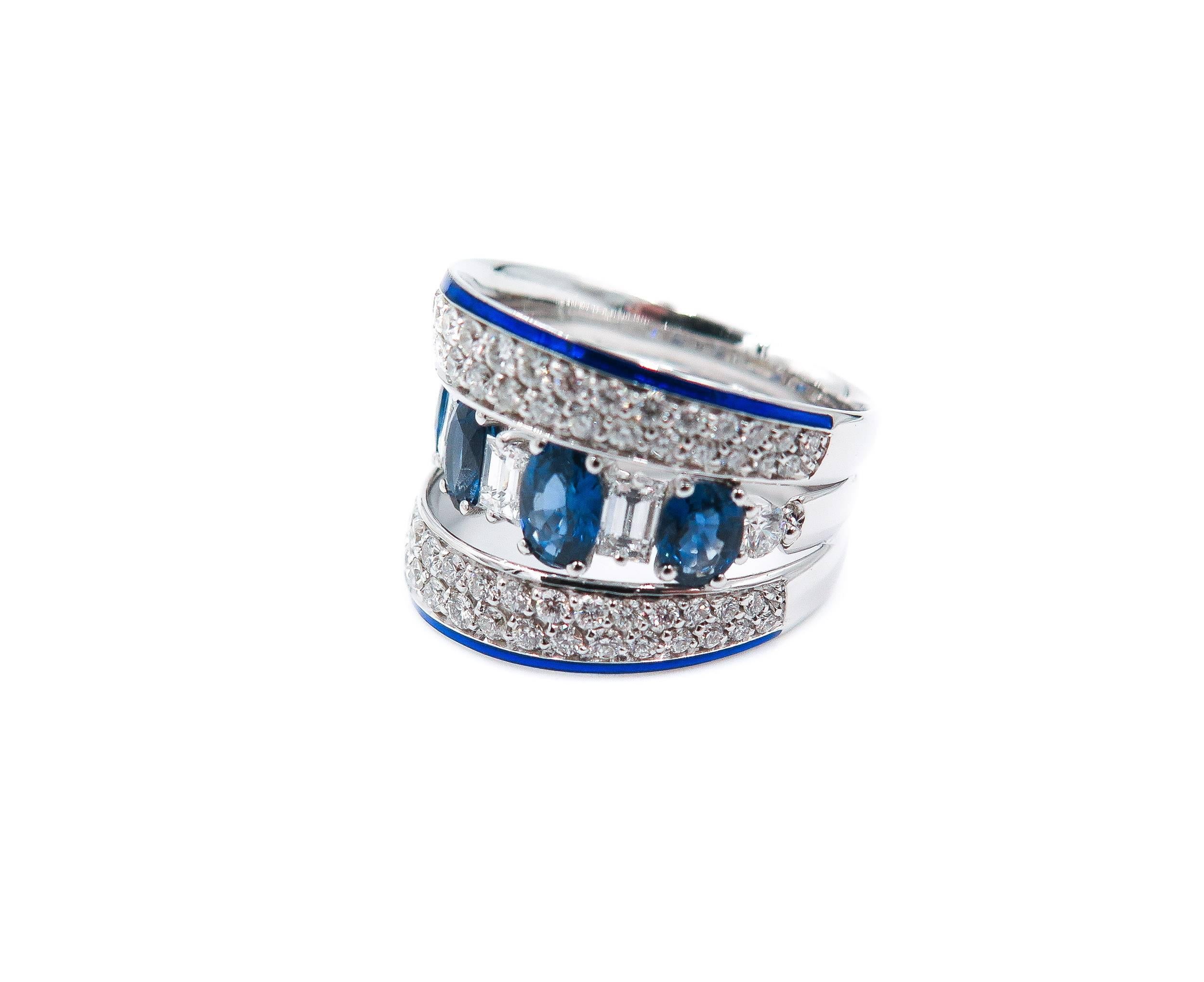 A beautiful 18k white gold diamond and sapphire dress band. 
The ring is comprised of 5 oval cut sapphires in a prong setting with a weight of 2.53 carat with a dark blue hue throughout. 
Complimenting these sapphires are 4 emerald cut diamonds in