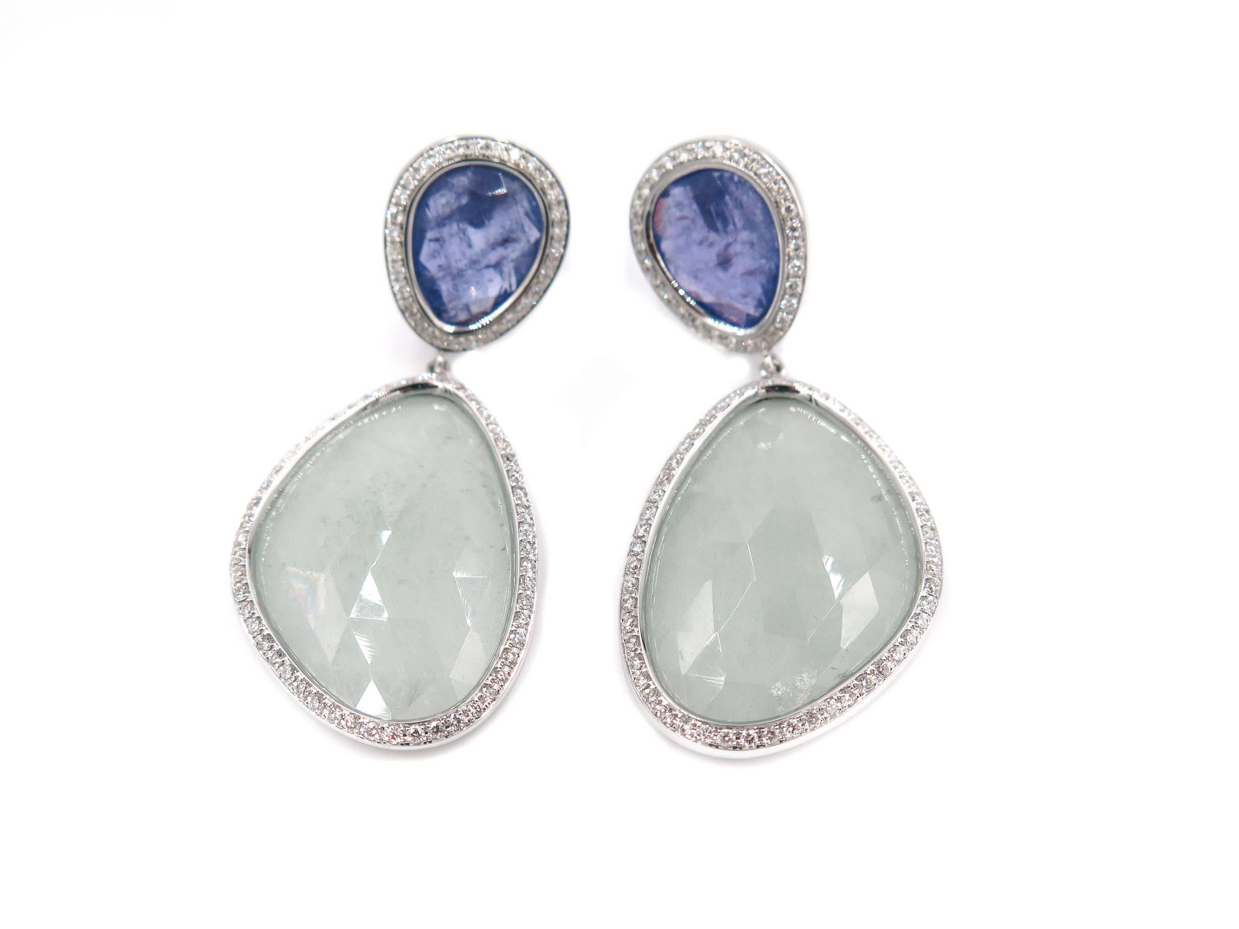 Magnificent one of a kind Aquamarine and Tanzanite Drop Earrings.
Designed and created by Portuguese designer Monseo in 19K white gold, delicately framed by a thin row of white round diamonds accentuating the natural beauty of the soft green