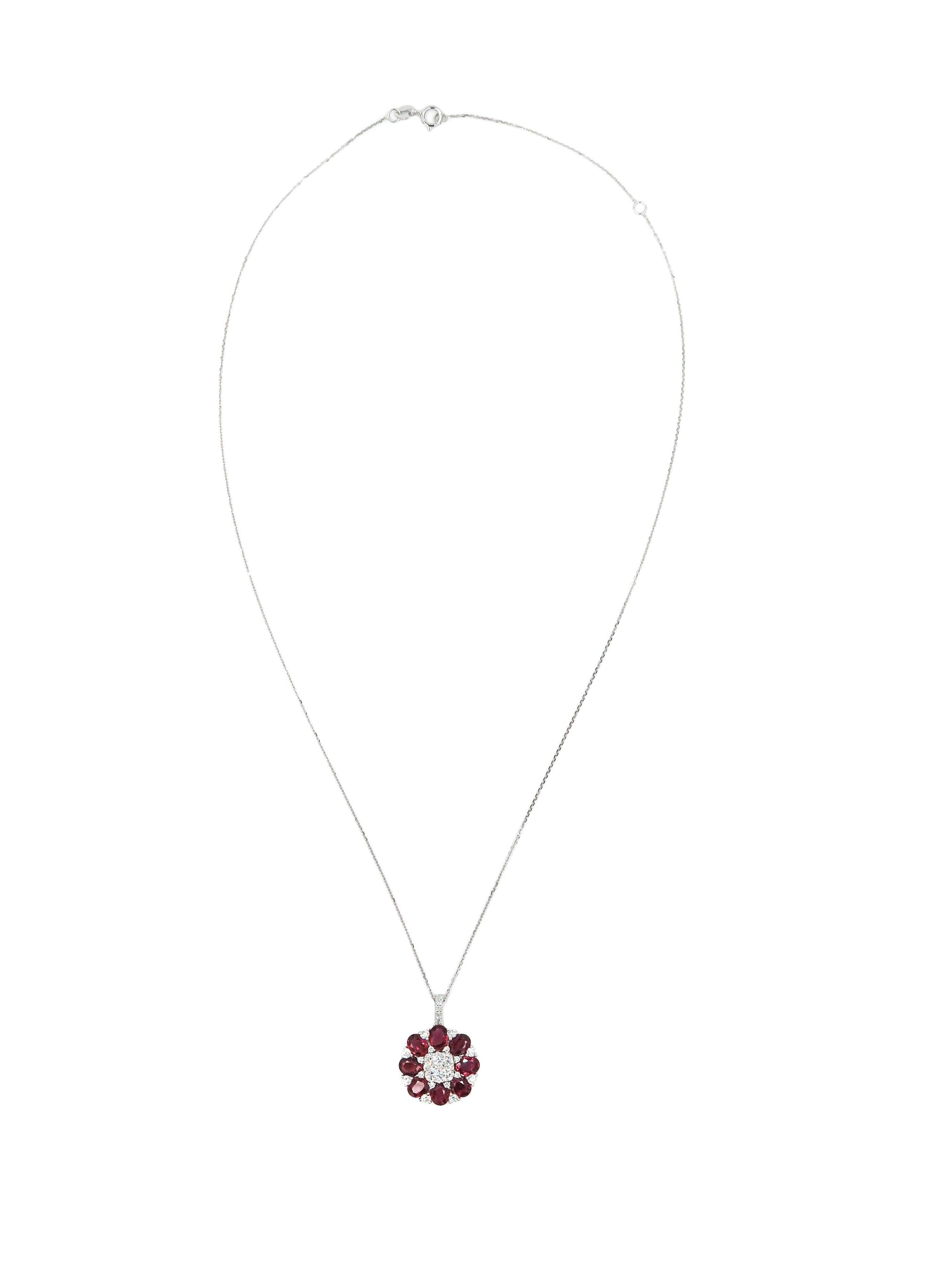 When words are not enough... colors and shapes can speak for themselves. 
Eight oval cut rubies, enriched by 31 round diamonds bloom into this beautiful pendant.  
Creatively crafted in 18 karat white gold, with 2.86 carats of ruby and 0.77 carats