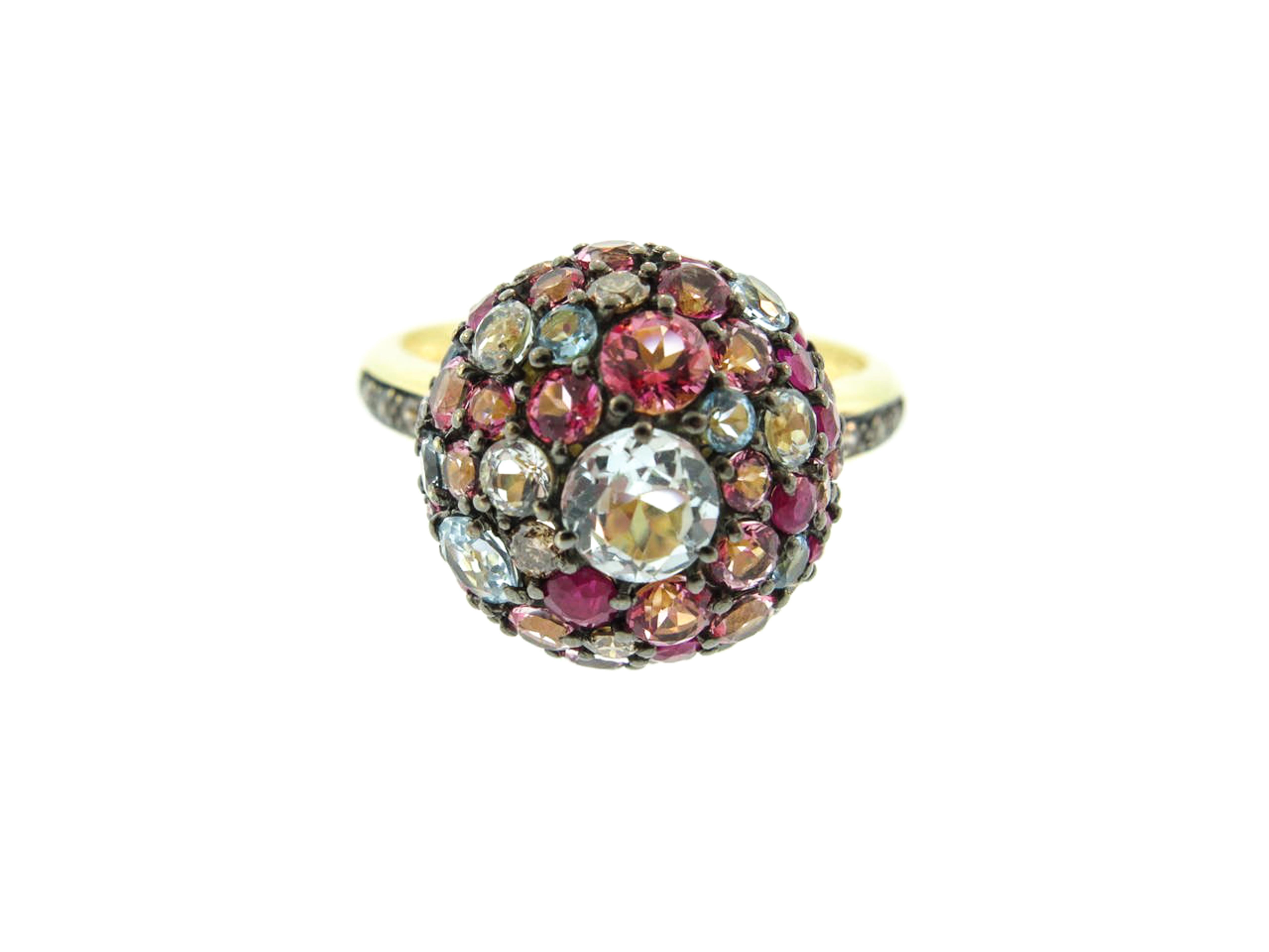 Ruby, blue sky topaz and pink sapphires makes this colorful domed ring more fun. 
Is handcrafted 18k yellow gold and finished with a black rhodium to intensify colors and create a contrast.
Crafted to fit a finger size 6.5 but can be sized