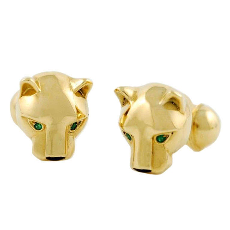 Cartier, a Pair of Onyx and Emerald Panther Cufflinks, each depicting a panther head, emerald eyes and onyx muzzle, mounted in yellow gold, with French hallmarks, gross weight 24.75 grams, signed Cartier, numbered 652151, circa 1980s.