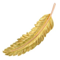 A Yellow and Rose Gold Feather Hair Clip