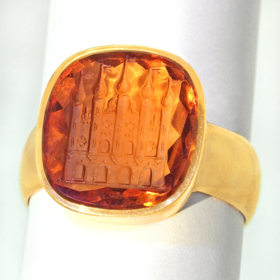 Circa 1920s, 14k, Germany or Switzerland.  This striking intaglio cut citrine ring has it all. Impressive size, interesting subject matter, superb quality and vivid color come together to make a bold style statement. The elegantly simple setting is