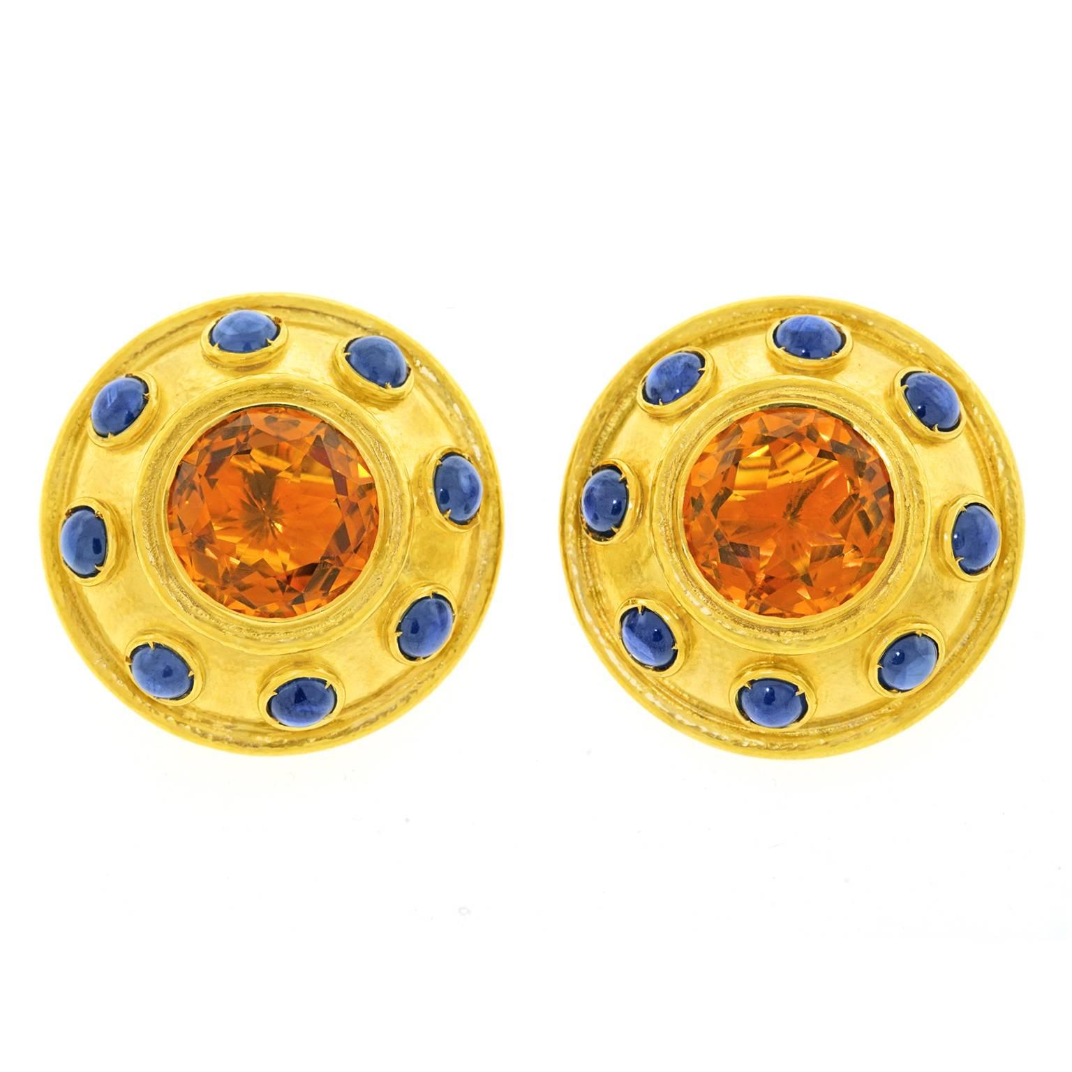 Circa 1980s, 22k, Zolotas, Greece.  These stunning classical motif shield earrings by Zolotas of Athens combine spectacular citrines with 12.0 carats of vivid blue sapphire. The graphic look of contrasting stones set in warm twenty-two-karat gold is