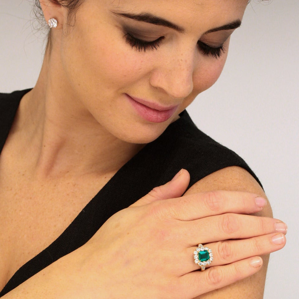 Circa 1960s, 18k, Van Cleef & Arpels, New York. Set with a stunning deep green 2.25 carat emerald surrounded by 1.45 carats of brilliant white diamonds, this VCA ring is a classic. The look is smart, understated and chic. It is a meticulously hand