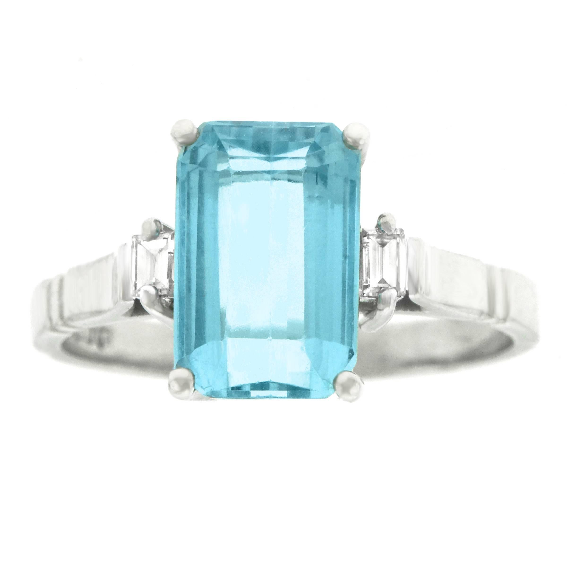 Circa 1976, 18k, London, England.  This colorful eighties ring is set with a 2.50 carat aquamarine framed by two superb diamonds (F color, VS clarity). Its refined modernist architecture gives it a sleek, sophisticated look. Meticulously fabricated