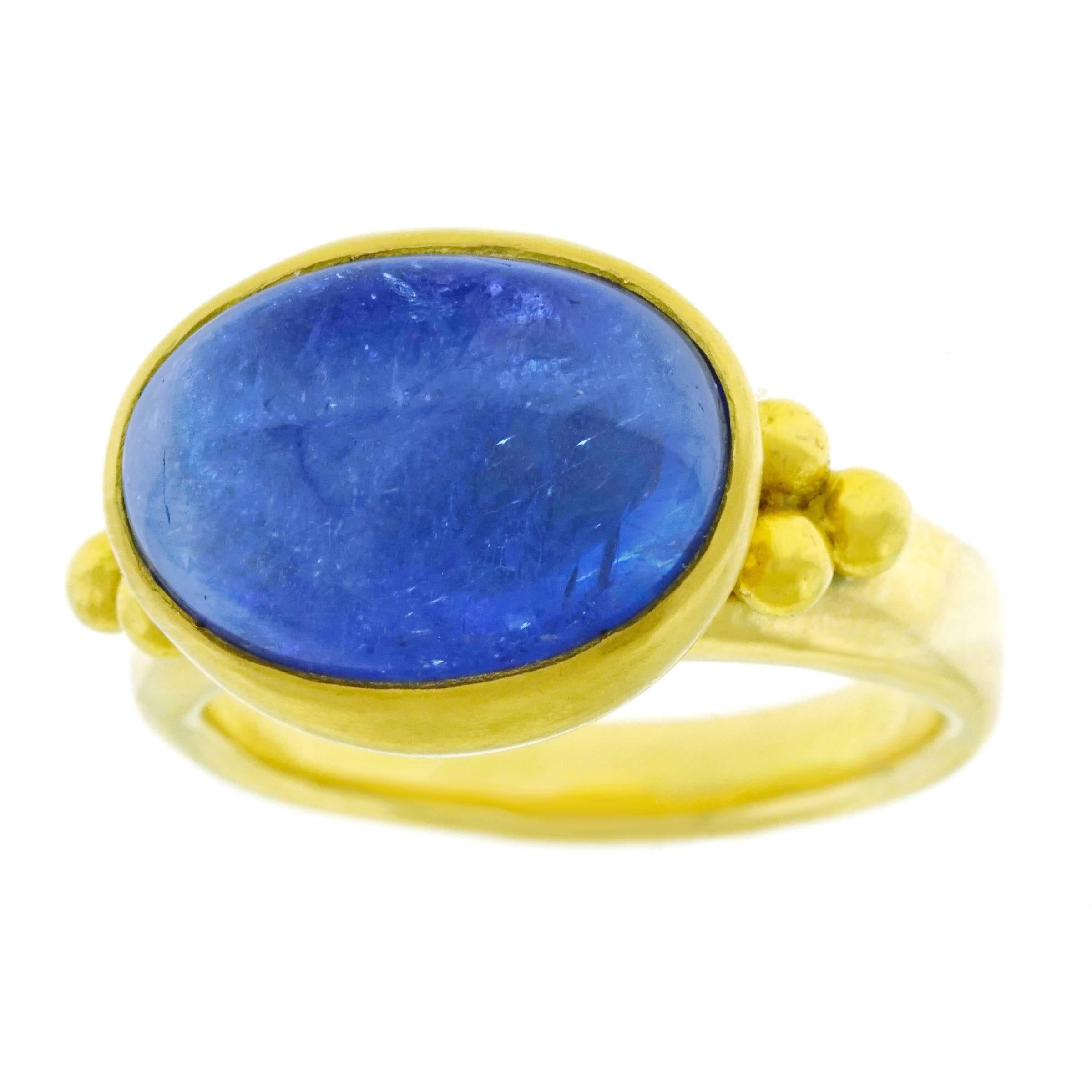 Circa 2000s, 22k/18k, Maija Neimanis, American.   This chic ring by Maija Neimanis is set with a vibrant tanzanite cabochon in polished high-karat yellow gold. Schooled in ancient techniques, Neimanis makes Byzantine-inspired design contemporary