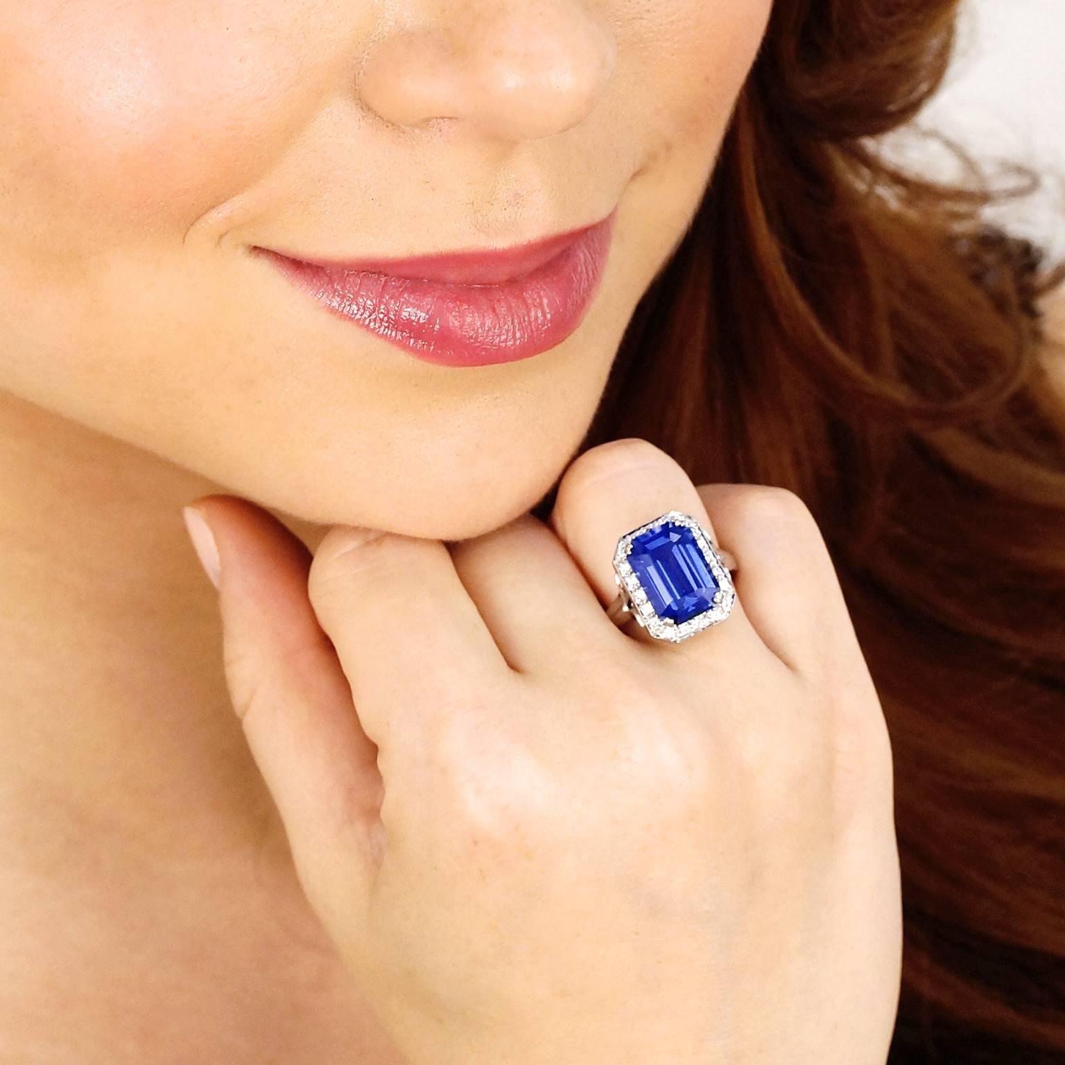 Circa 1980s, 18k, American. This ring is all about the lush 7.0 carat emerald cut tanzanite. Its brilliant deep lavender-blue color is sublime. Additionally set with .48 carats of superb white accent diamonds, this ring features classical design and