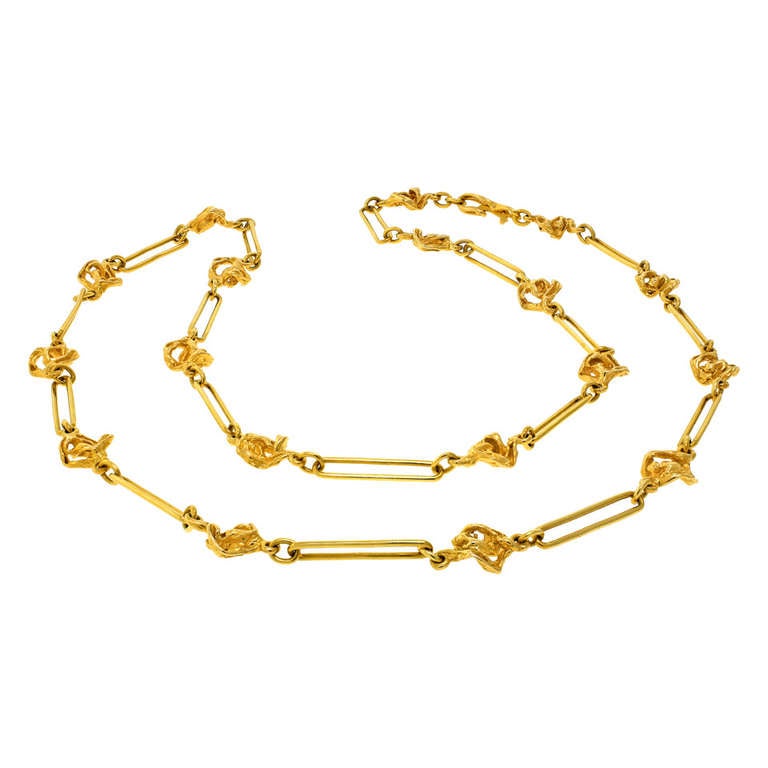 Geneve, Switzerland.  This modernist necklace from renowned designer Gilbert Albert has an easy organic vibe. The chic length draws the eye to the unusual abstract shapes of the links and the bright yellow 18k gold gives it a warm feel.  Superbly