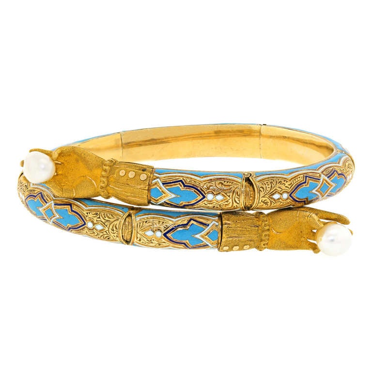 This Moresque taste bracelet has a wonderfully chic visual complexity. Champlevé enamel in three colors mix with delicate engraving and bloomed textured gold for a cheerfully sophisticated look. The hands symbolize love and friendship, while the