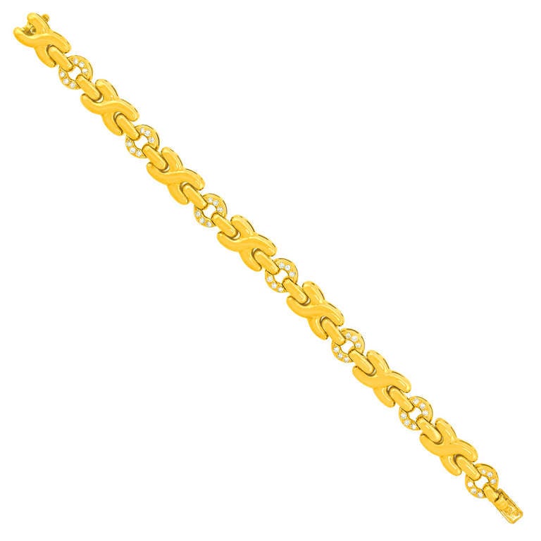 This Parisian designed bracelet has a playful motif of X’s and O’s.  Polished yellow gold and bright white diamonds (G color, VS clarity) complement each other and transition smoothly from day to night wear.  It is finely constructed in 18k gold.  