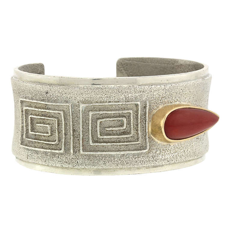 This unique bracelet by the award winning artist Edison Cummings, combines traditional Navajo tufa stone fabrication with modern design motifs. The look is nuanced, with different textures and colors giving it elegant visual appeal. Tufa stone