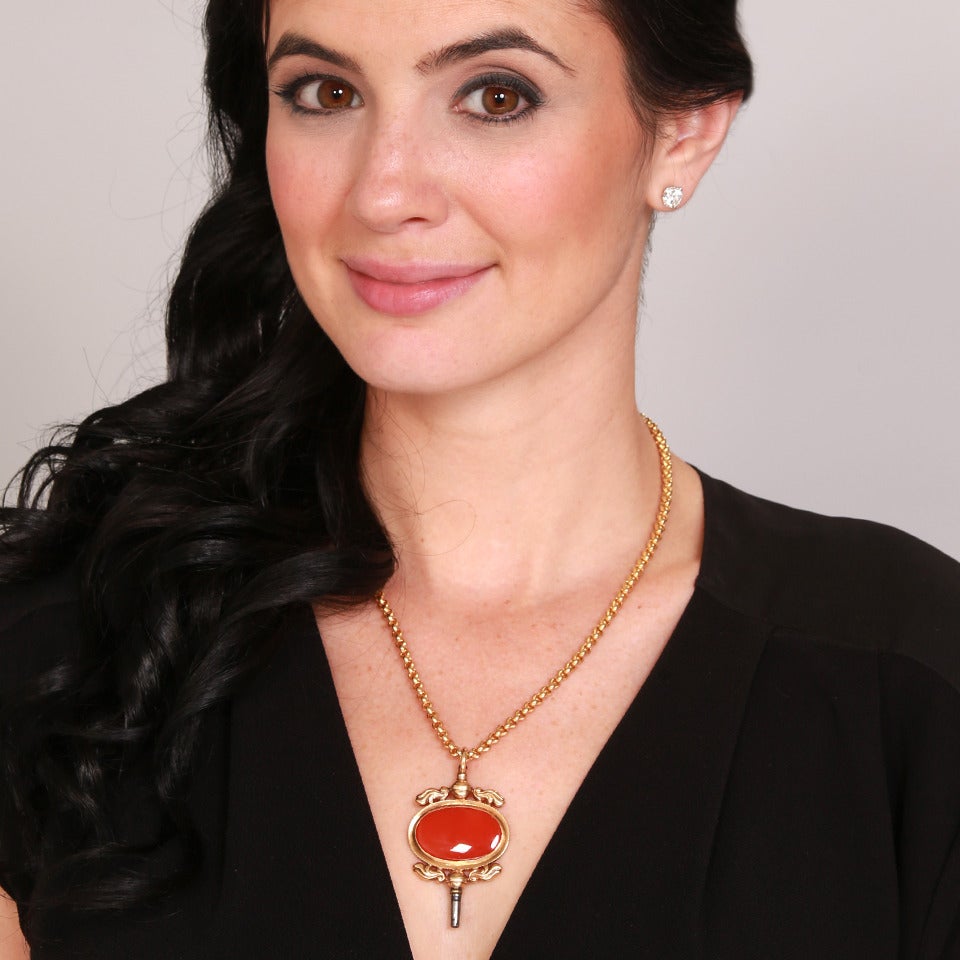 Circa 1870-80s, 14k.  This rare, oversized watch key makes an inspired pendant. Charmingly decorated with a foliate motif and set with a lush cabochon carnelian, the look is authentic vintage chic at its cool found-objects-as-jewelry best.