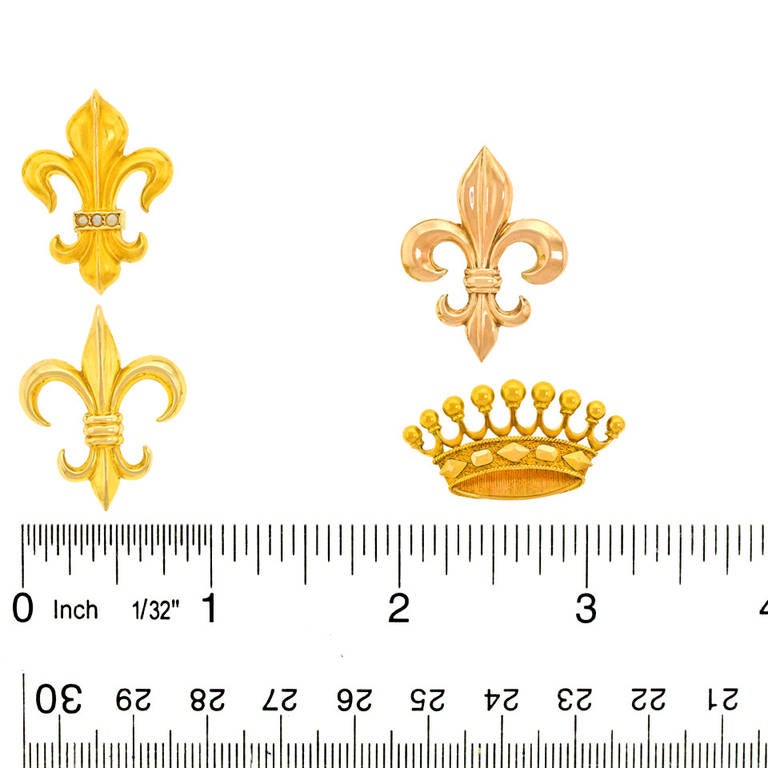 Grouping of Four Fleur-de-Lis and Crown Brooches 1