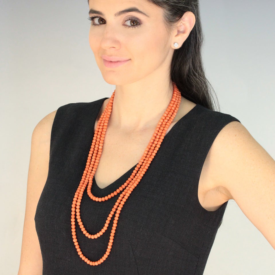 Circa 1920s, 14k antique catches, Italian coral.  This wonderful natural coral necklace is a decadent 84 inches long, a fantastic length that can be worn as a single strand or in two, three or four layers. Colorfully stylish, its look can be smart,