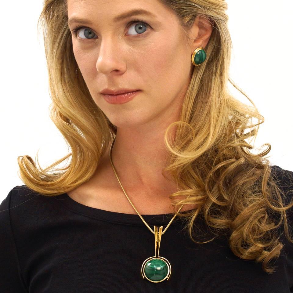 Circa 1970s, 18k, Swiss. This fabulous post-modern pendant features an innovative design that blends biomorphic with industrial. Completing the narrative, the bright color and superb figure of the malachite contrasts beautifully with the sleek gold