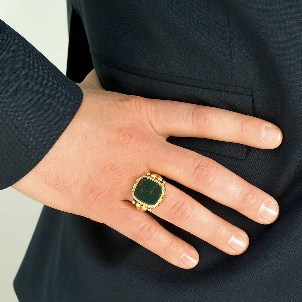 Circa 1880s, 14k. This antique signet ring features a beautifully-figured bloodstone set in an outstanding mounting. From the intricate scrolled gallery to the Georgian-style fluted underside, the ring is substantial and stylish. Meticulously made,