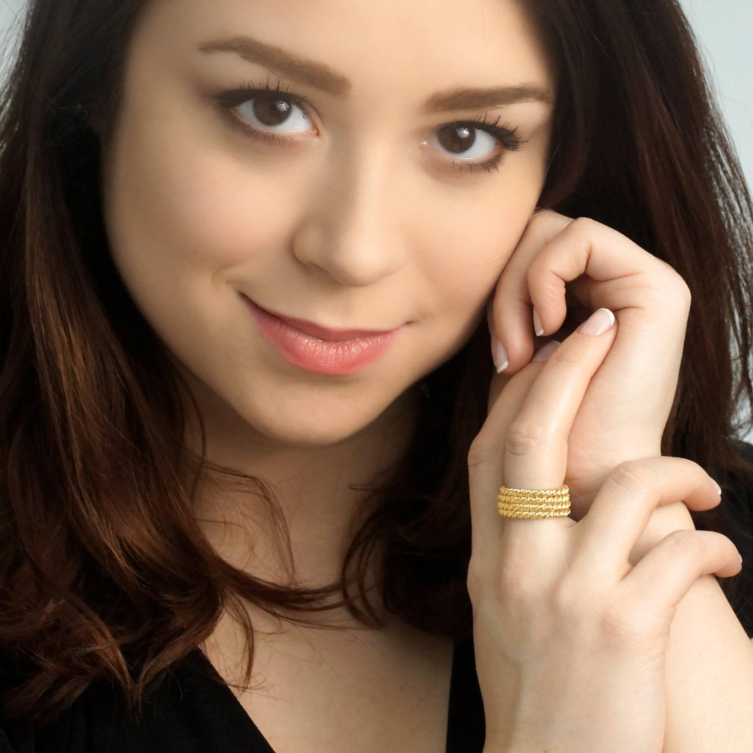 Circa 1980s, 18k, Tiffany & Co., New York City. This chic 18k gold ring from Tiffany & Co. features four joined bands of textured gold rope. The perfect everyday yellow gold ring, it is comfortable on the hand and is finely made.  Excellent