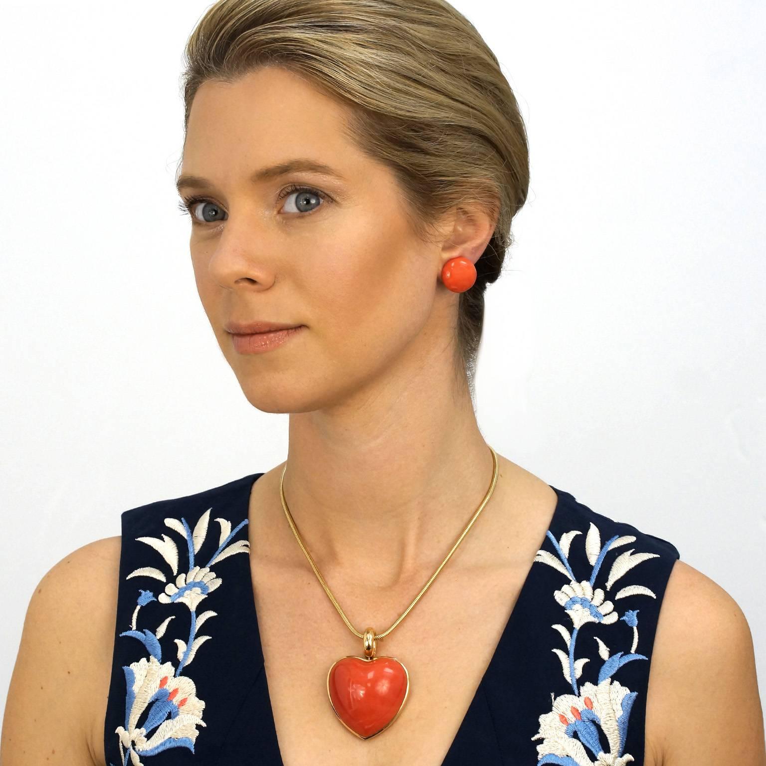 Circa 1950s, Attributed Italy.  A modernist take on the definitive button earring, these chic natural coral cabochons add a pop of lush color to any moment of fashion. Needing no artifice to achieve brilliant minimalism, the single brush stroke of