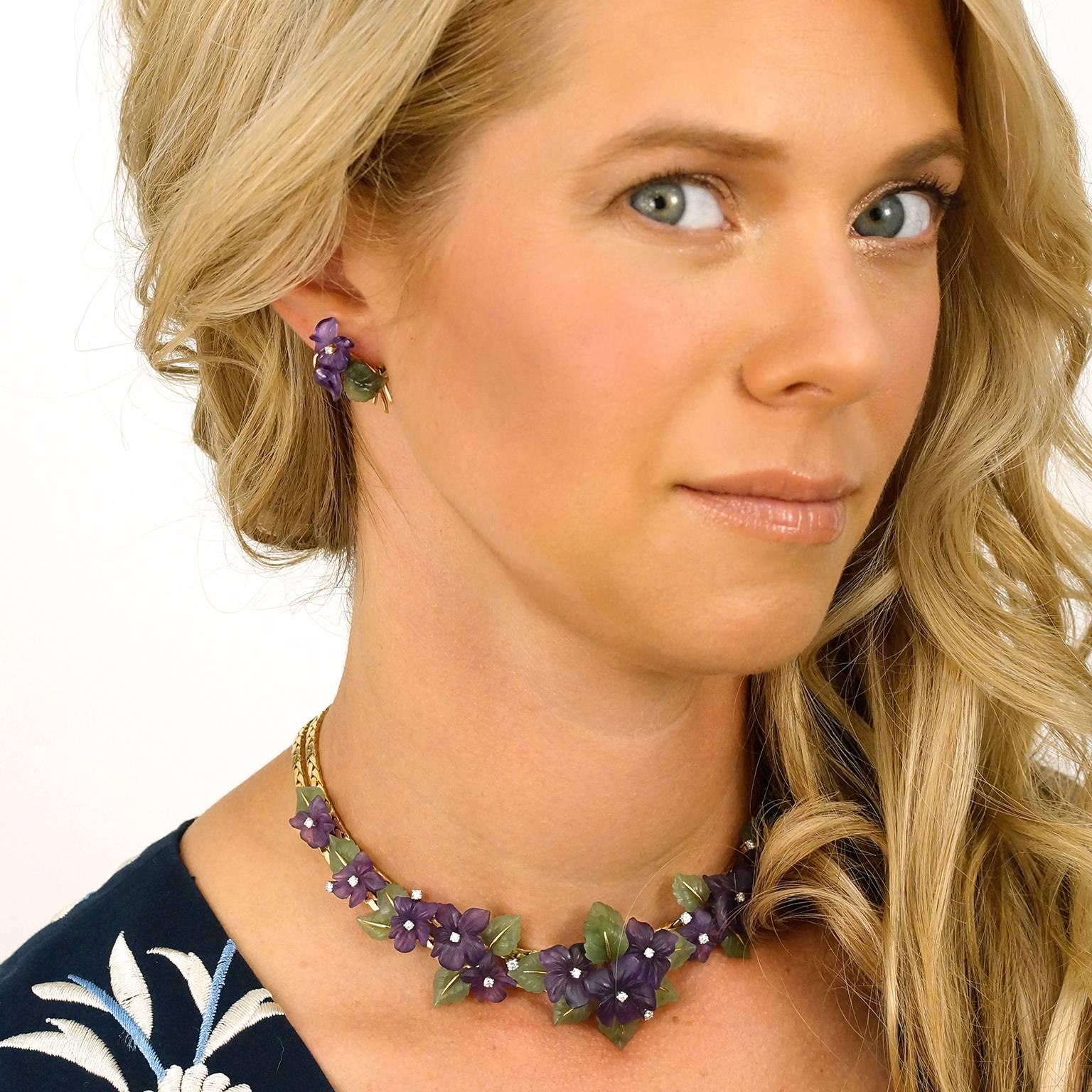 Circa 1950s, 18k, Austria.    Nature’s beauty abounds in this splendid pair of carved hardstone earrings. Vivid amethyst flowers cheerily open in full bloom, each enhanced by a brilliant diamond, while lush jade leaves and gold accents complete each