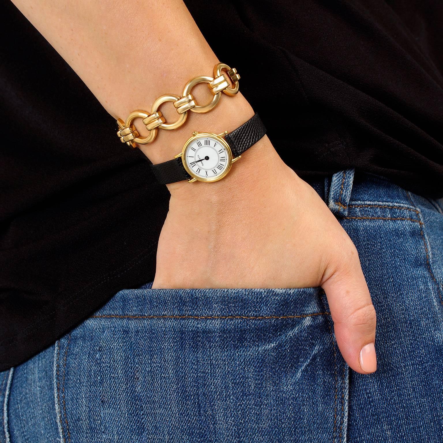 golden watch with roman numbers