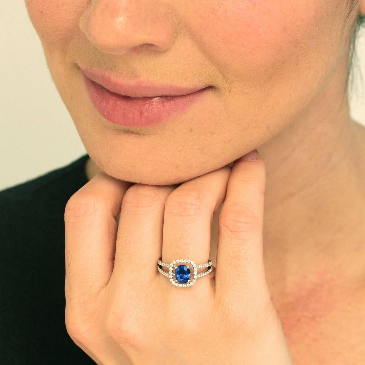 Circa 2000, 18k, American. Sleek contemporary design, bright white fire, and lush blue color come together in this stylish ring. The 1.31 carat cornflower blue sapphire is gorgeous, and the .53 carats of diamonds are of superior quality. The