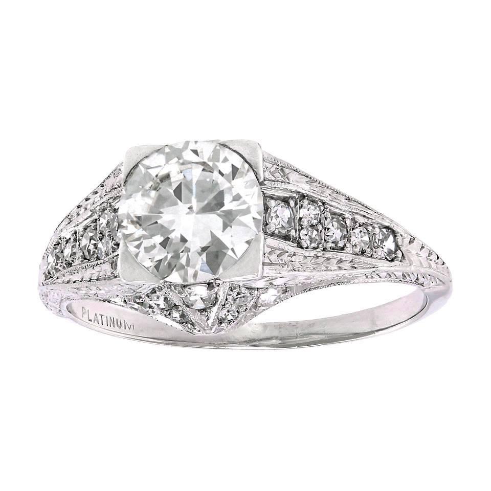 Circa 1950s, Platinum, American.  Set with a stunning 1.14 carat brilliant white diamond (F color, VVS1 clarity), this vintage fifties Art Deco filigree ring is gorgeous. The exquisite detail and fine accent diamonds, set in elegant polished