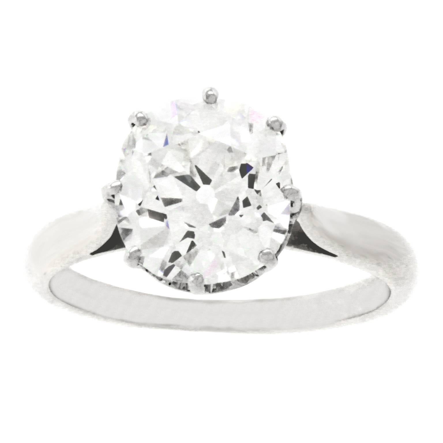 Circa 1920s, platinum and 18k, France.   The crowning glory of this elegant French Art Deco ring is its brilliant white 3.15 carat mine-cut diamond (GIA Report #GIA Report #5172846402, J color, VS1 clarity). Lively and bright, superb clarity gives
