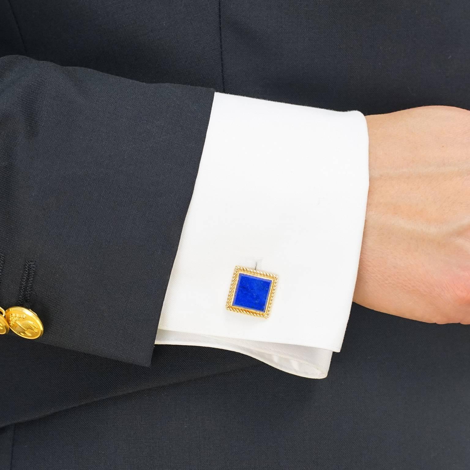 Circa 1950s, 14k, Tiffany & Co., American.  These elegant fifties cufflinks by Tiffany & Co. feature lush, finely figured gold-flecked lapis framed in a classic cable-twist border. Made in eighteen-karat yellow gold, they will add a harmonious