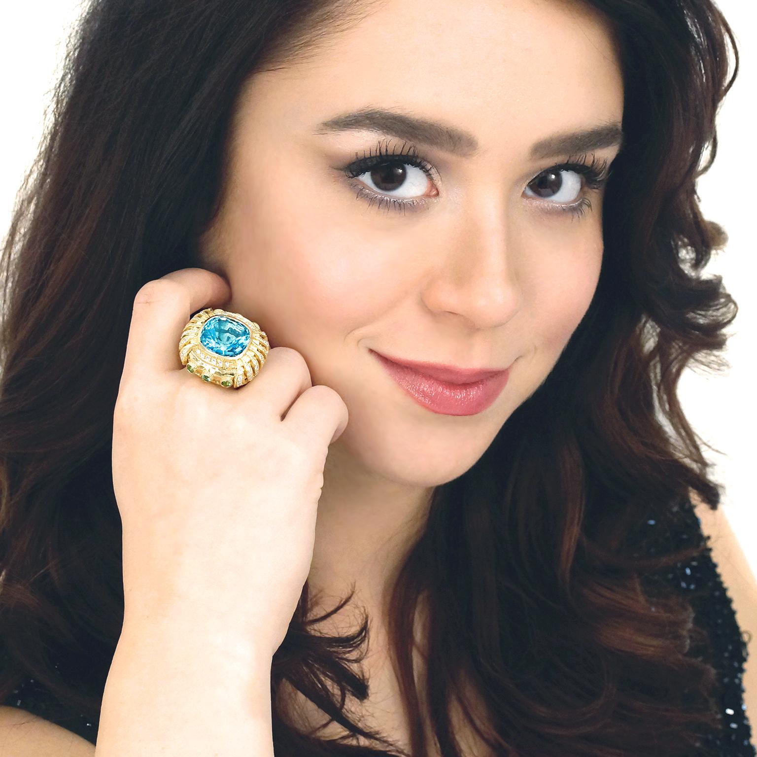 Circa 2006, 18k, American.  At the center of this organo-chic ring a magnificent 14 carat deep blue aquamarine splashes color on its elegantly surreal landscape. Its psychedelic look is underscored by a nuanced approach to hand-wrought detail such