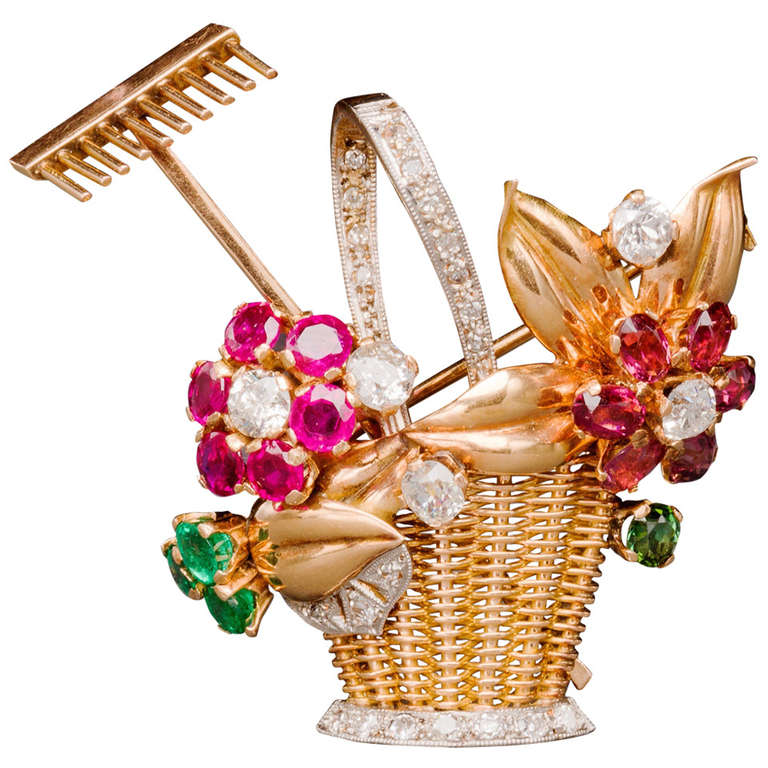Of two color 18k gold, this delightful jardiniere or giardinetto pin from the 1940s is designed as a yellow gold hand-woven basket adorned with rubies, emeralds, pink and green tourmaline and diamond flowers, enhanced with polished rose gold leaves