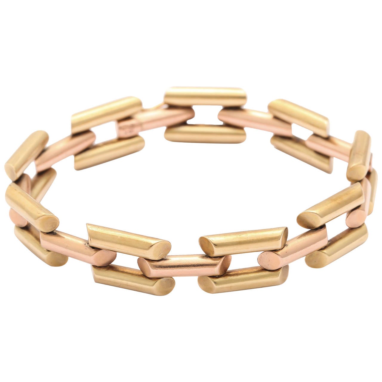 Designed as a line of parallel double bar links of yellow gold connected by single rose gold bar links of similar design, one end fitted with a slide clasp and safety device. The tubular links are bevelled at the ends, adding to the angular retro