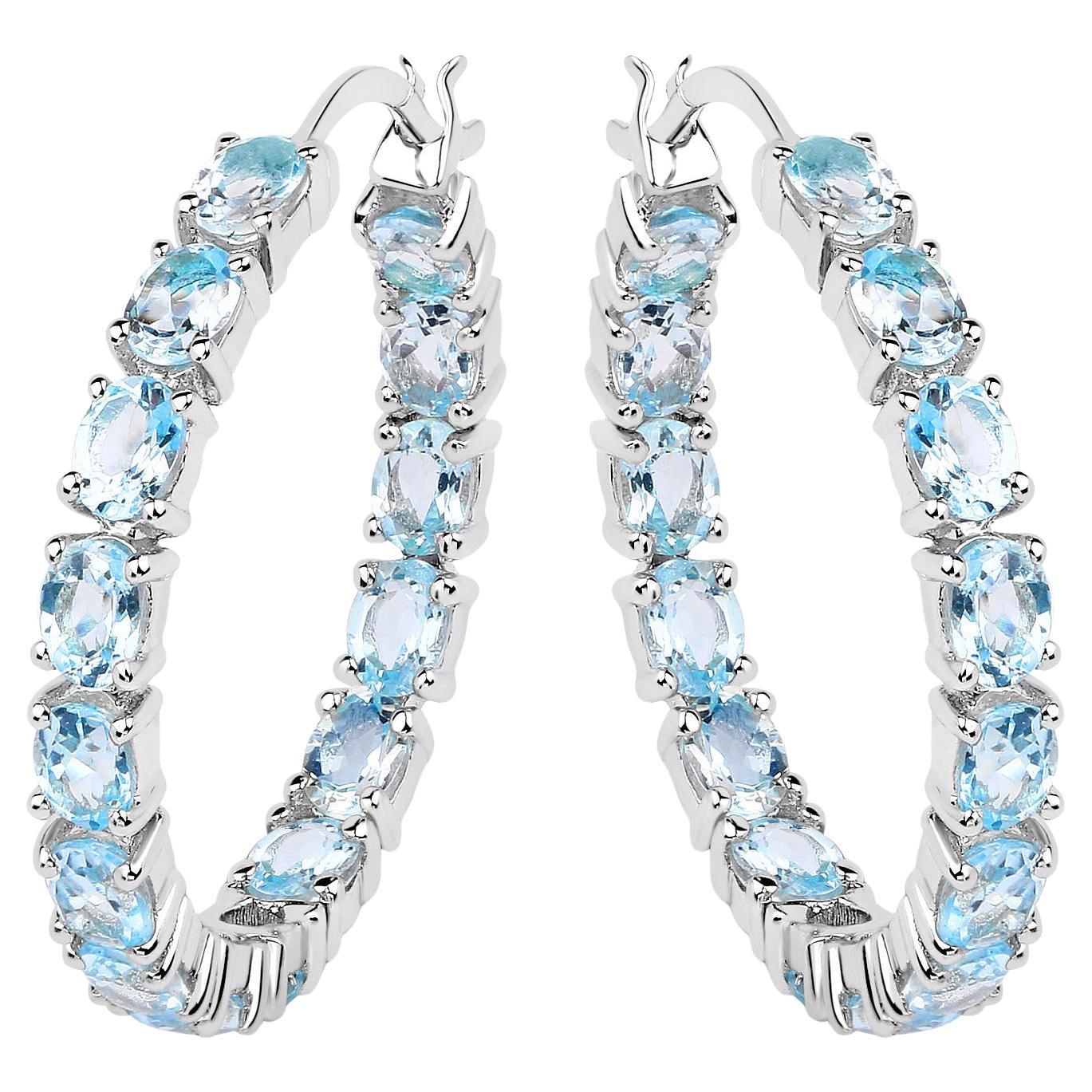 Créoles en argent plaqué rhodium avec topaze bleue naturelle d
un total de 5,70 carats