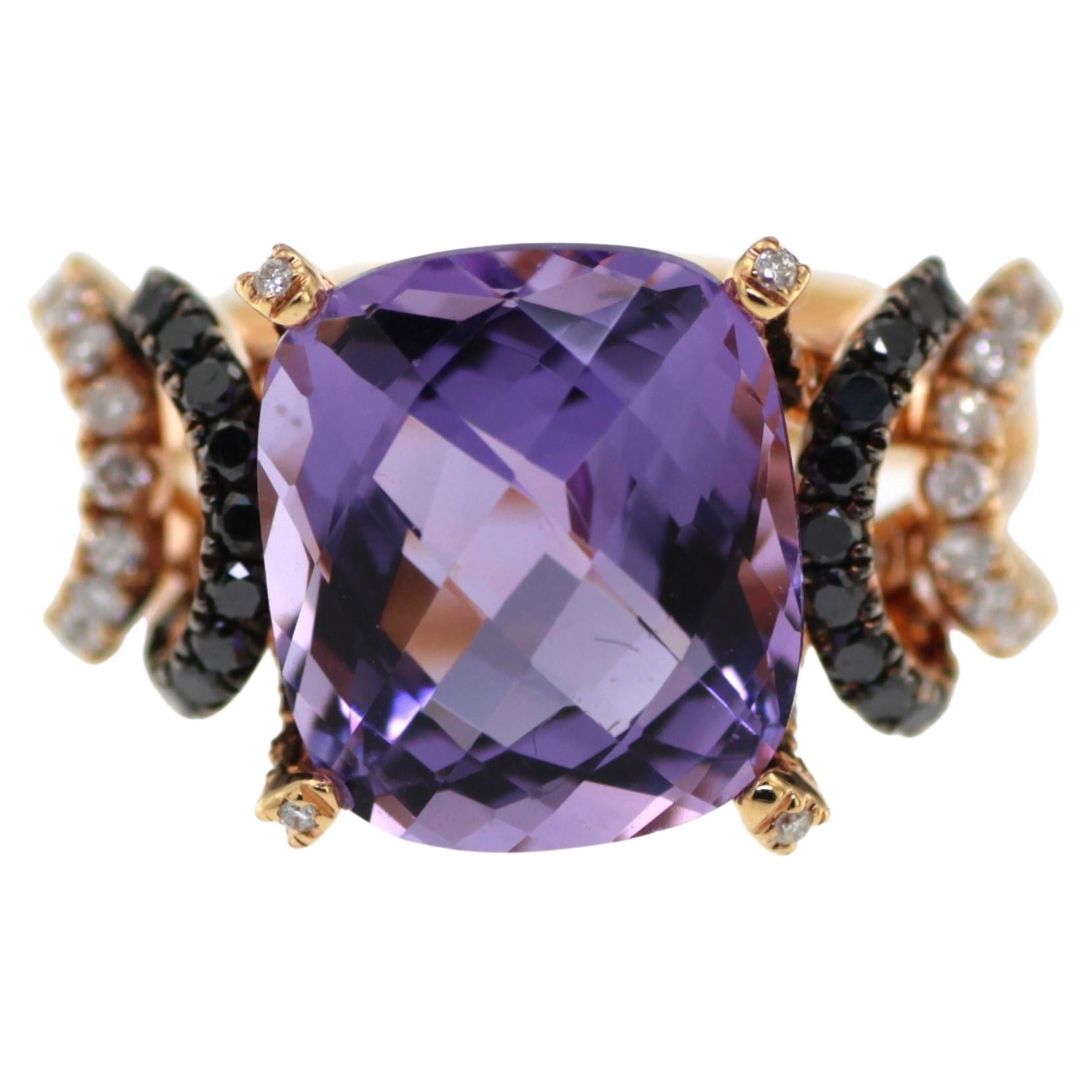Indulge in the mesmerizing beauty of our exquisite Amethyst and Diamond Ring set in 18 Karat Rose Gold. This captivating piece showcases a magnificent 6.44 carat cushion-cut amethyst, radiating a stunning purple hue that captures the
