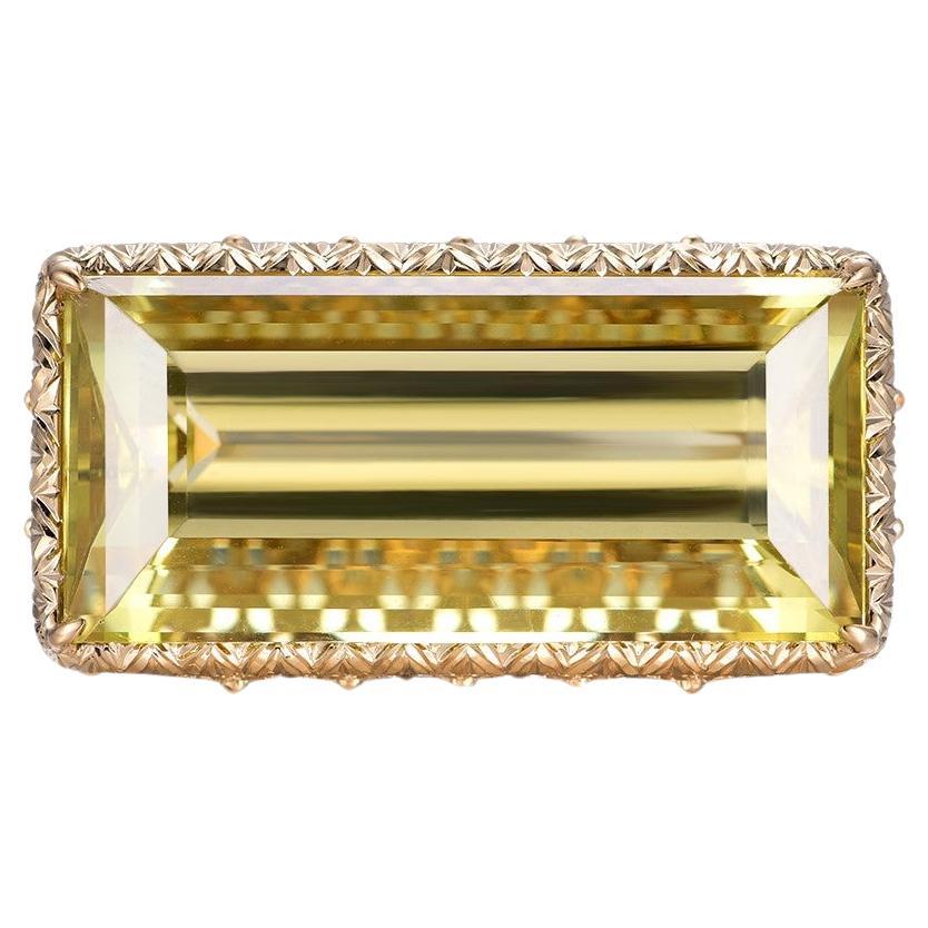 An exquisite vintage ring, masterfully crafted in a blend of 18K yellow and white gold, showcasing the elegance of a bygone era. The centerpiece of this remarkable ring is a radiant rectangular-cut golden beryl, weighing an impressive 25.59 carats.