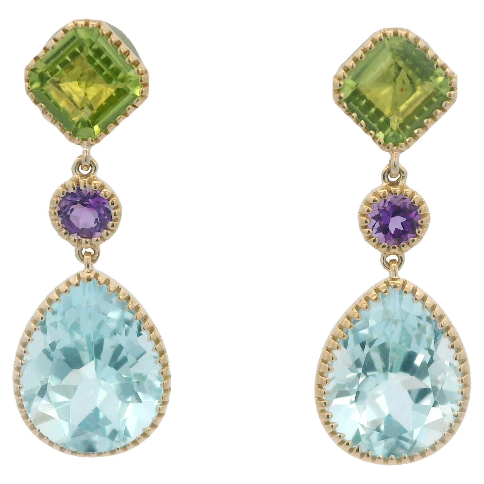 Celebrate elegance and vibrancy with these exquisite 14-karat gold drop earrings.  Designed to captivate, the earrings feature a dazzling 5.88-carat teardrop blue topaz as the centerpiece, radiating cool tranquility.  Above it, a delicate 0.2-carat
