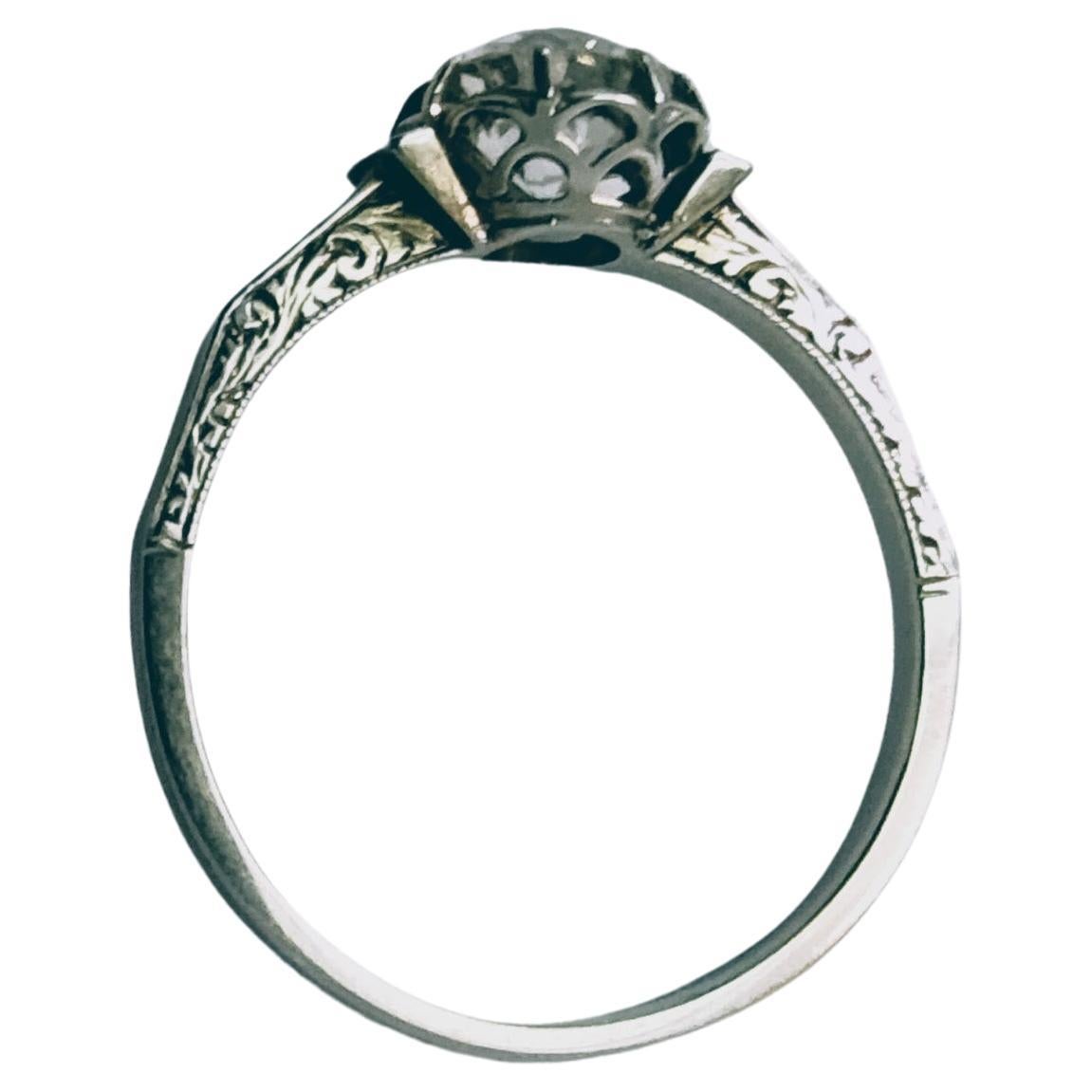 Beautiful antique Solitaire Ring set in prongs and beautiful engraving on its sides. Make in Paltinum weight 2.34grs, with a Diamond cut old European size 5.75x 5.75 x 4mm weight 0.84 carat approximate estimation color I Clarity VS1.

