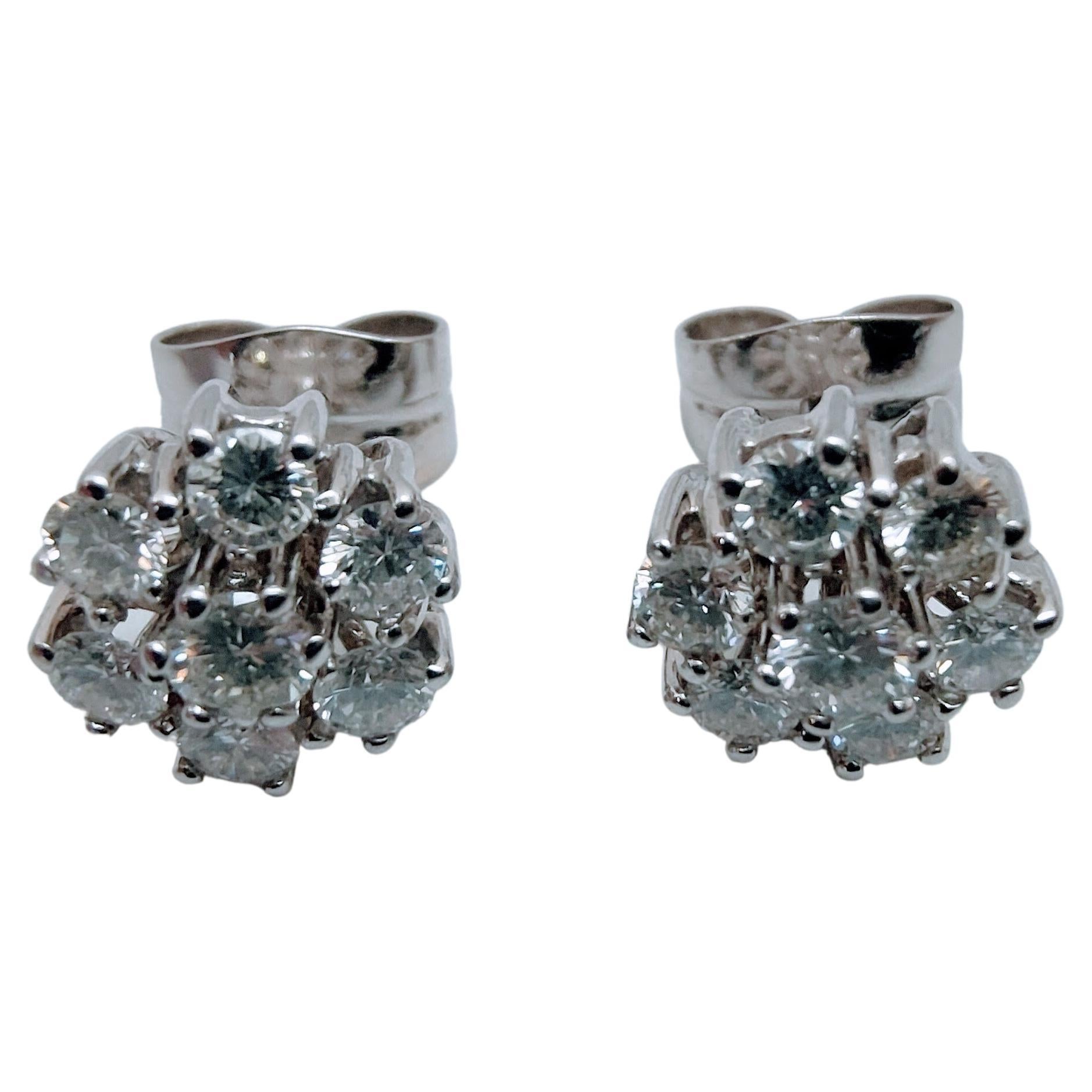 
Ideal Cluster stud Earrings White gold 18 Karat weight 4.91 grams. Central Diamond 0.40 carats total  pair color G clarity VS1 and 12 diamonds in the halo of 0.15 carats each weight 1.80 carats tyotal  pair.Color G-H Purity VS1. Brilliant