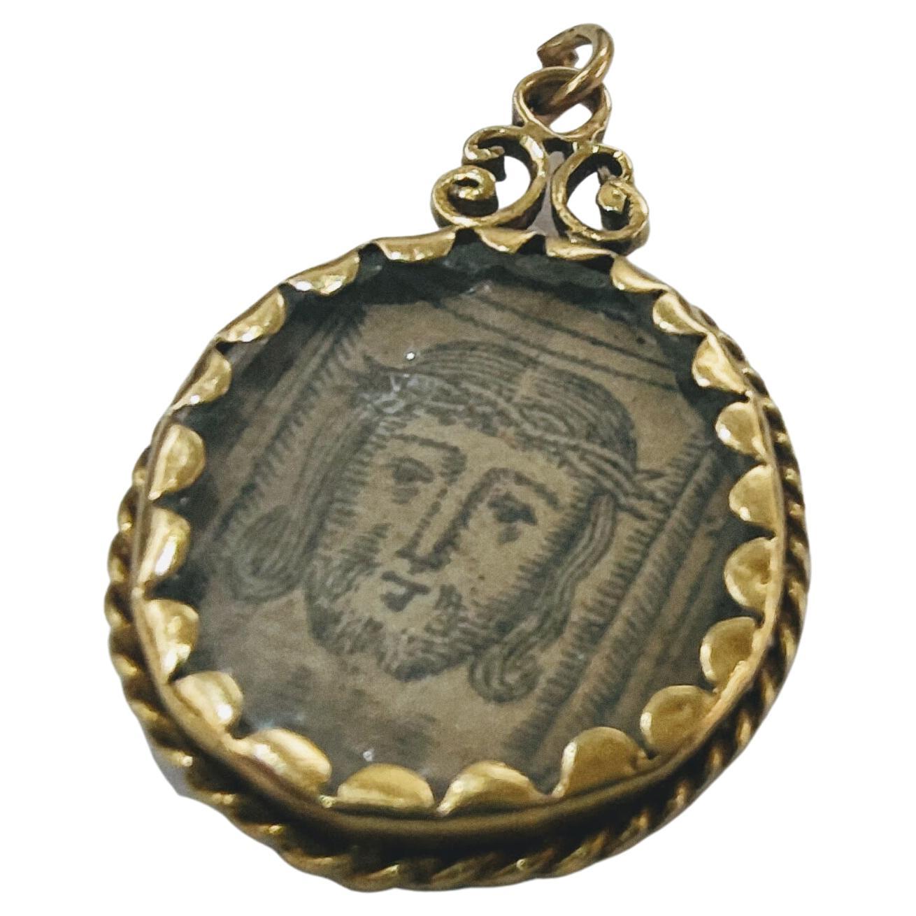 Devotional Medal Reliquary with printed image of the Virgin and Child and the Holy Face on the reverse S: XVIII yellow gold 18 kts weight 4.79 grs. 
