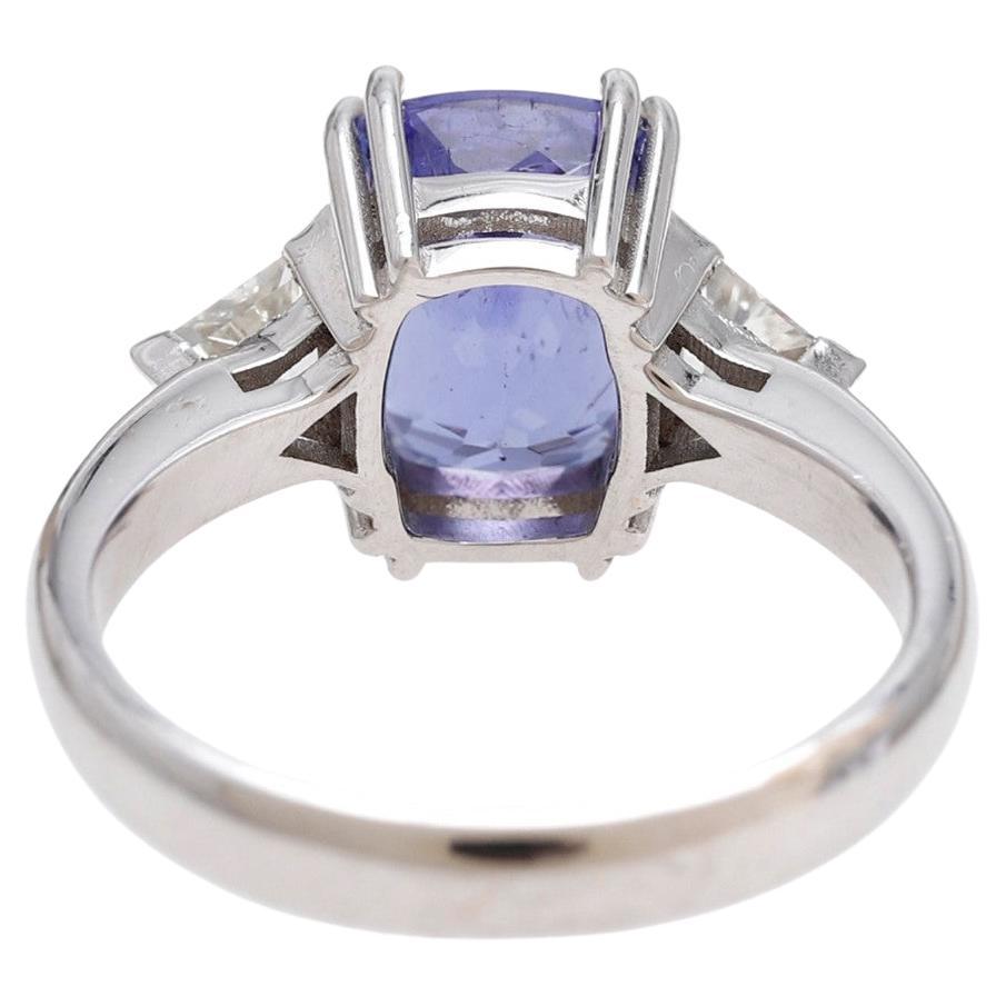 Three-Stones Ring White Gold 18 Kilates 5 grams Tanzanite  3.52 carats cushion cut set in double prongs and pair of Diamonds trilliant cut weight 0.45 carats colour H-I clarity VSI-SI1.
Ring Size: 13 Europe/ 53.1 American


