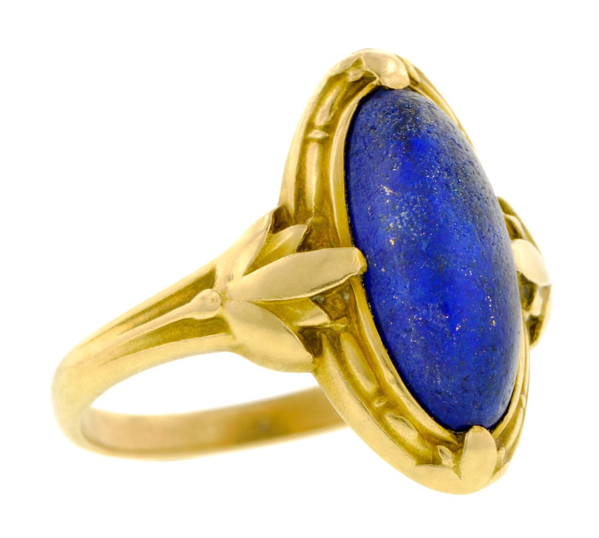 Art Nouveau lapis ring featuring an oval lapis measuring app. 12.5 x 6.0mm, with stylized lotus blossom detail on shoulders, fashioned in 14k. Unidentified maker's mark. Circa 1900. Size 5