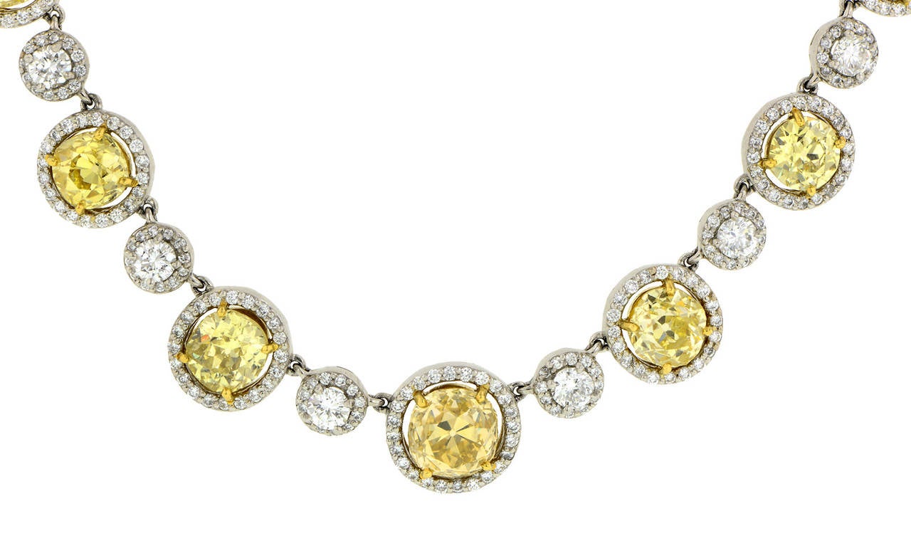 Fancy Yellow Diamond Necklace featuring nine, fancy yellow, Old Mine cut diamonds (listed below) weighing app. 8.90ctw., and 45 Round Brilliant cut diamonds weighing app. 6.51ctw., each in a surround of Round Brilliant cut diamonds weighing an