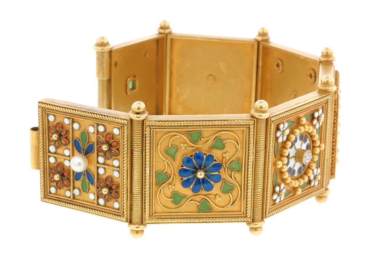 Vintage Renaissance Revival Style Bracelet measuring app. 1 1/4 inches wide, featuring pearls*(4.0mm), diamonds (0.30ctw.), a square cut emerald (4.0mm) and elaborate enamel & gold work on seven hinged panels, fashioned in 18k. Last half 20th