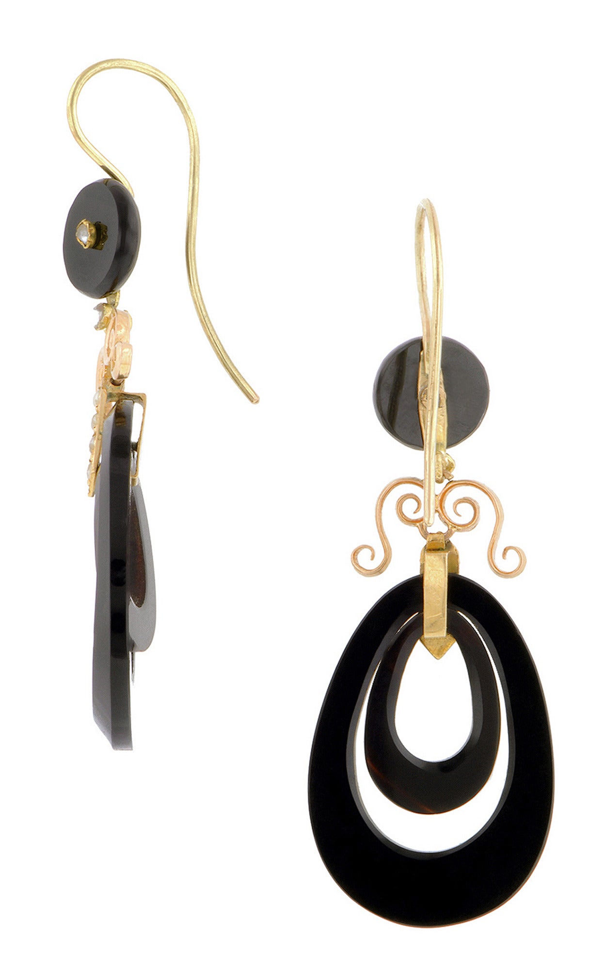 Victorian onyx drop earrings featuring concentric, pear shaped hoops, with scroll and seed pearl (1.0 - 1.5mm) tops, fashioned in 18k. Circa 1880. Length 2 1/8 inches (including ear wire).