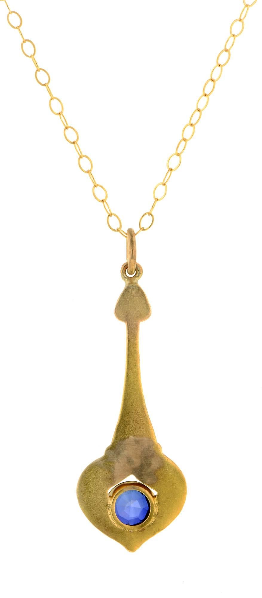 Art Nouveau sapphire drop pendant measuring app. 1 (including bail) x 3/8 inch wide, set with sapphire measuring app. 3.0mm in a pendulum-like design, fashioned in 10k bloomed gold. Suspended from a 16 inch chain. Circa 1900
