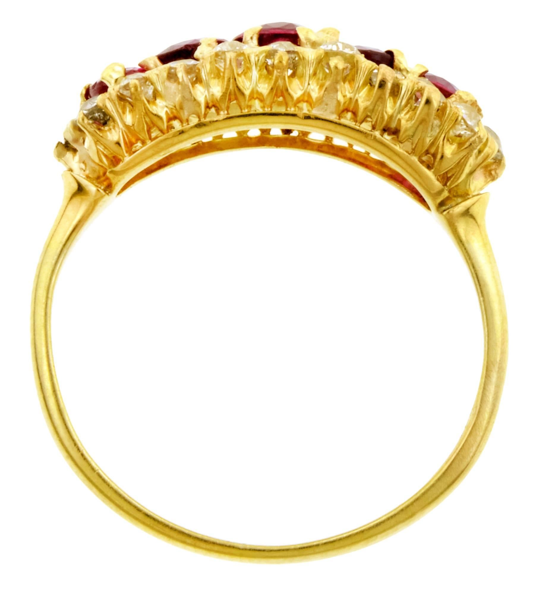 Victorian ruby & diamond ring centering five graduating oval brilliant cut rubies weighing approx 1.14ctw, framed by twenty round mixed cut diamonds weighing approx 0.40ctw. Cluster design, fashioned in 14K yellow gold. C.1860. size 5.