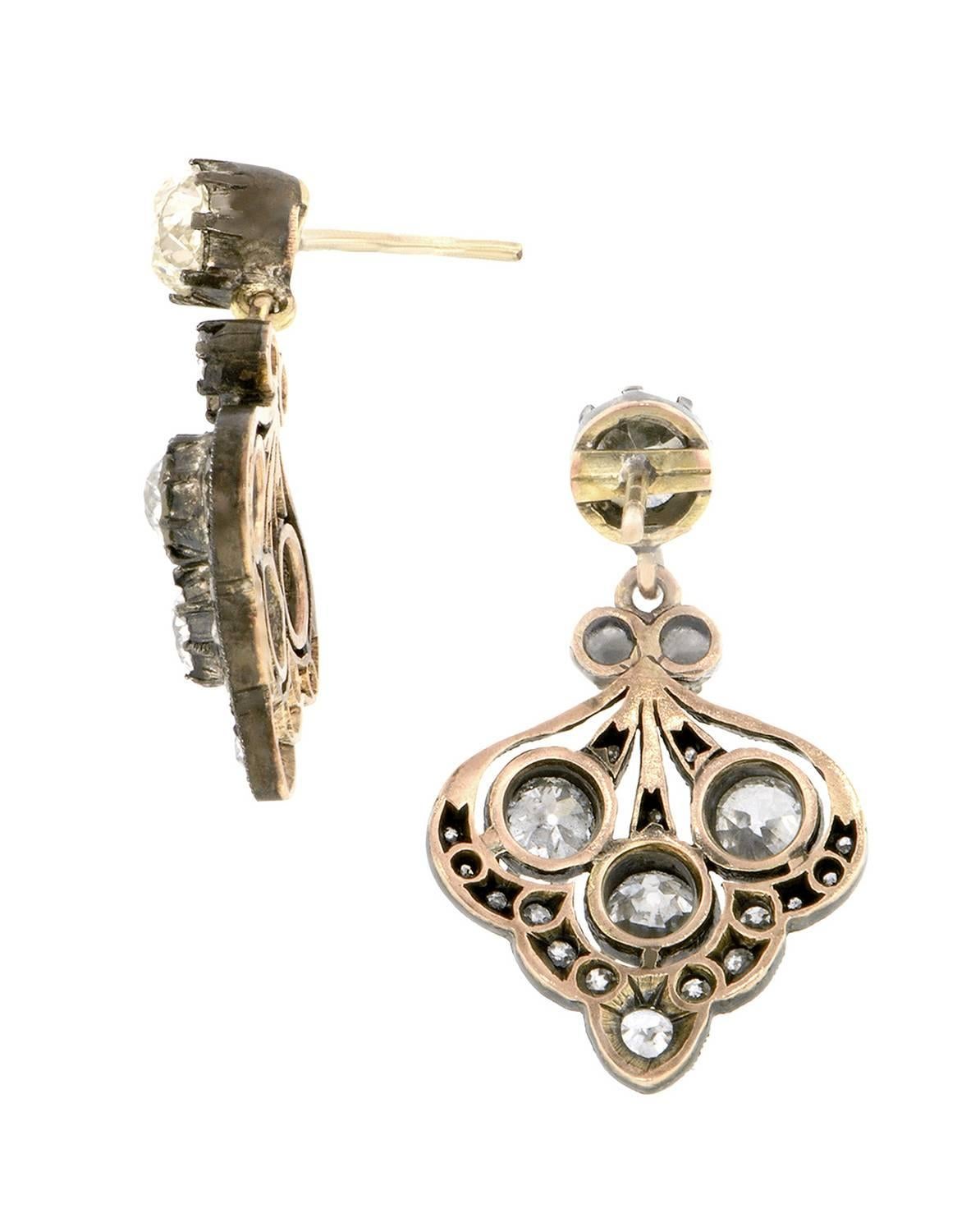 Diamond drop earrings measuring app. 2 1/8 x 11/16 inch wide, featuring Old Mine cut, Old European cut, Round Brilliant cut & Single cut diamonds, all weighing app. 4.68ctw.(top stones app. 0.80ct & 0.88ct), in an antique-style design, fashioned in